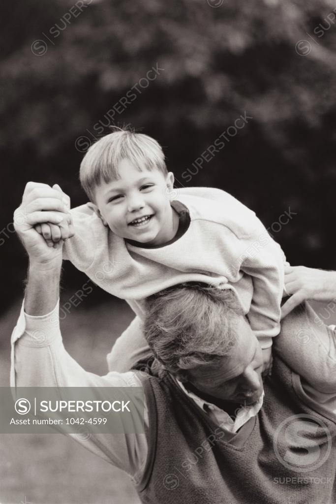 Stock Photo: 1042-4599 Father carrying his son on his shoulders