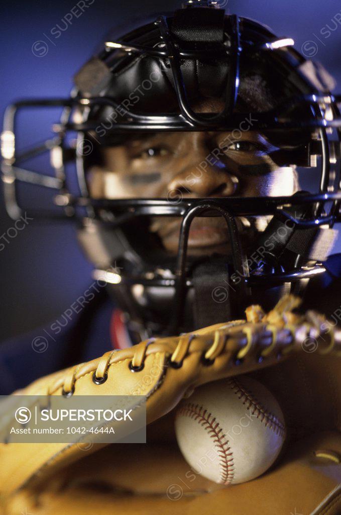 Stock Photo: 1042-4644A Portrait of a baseball catcher holding a baseball