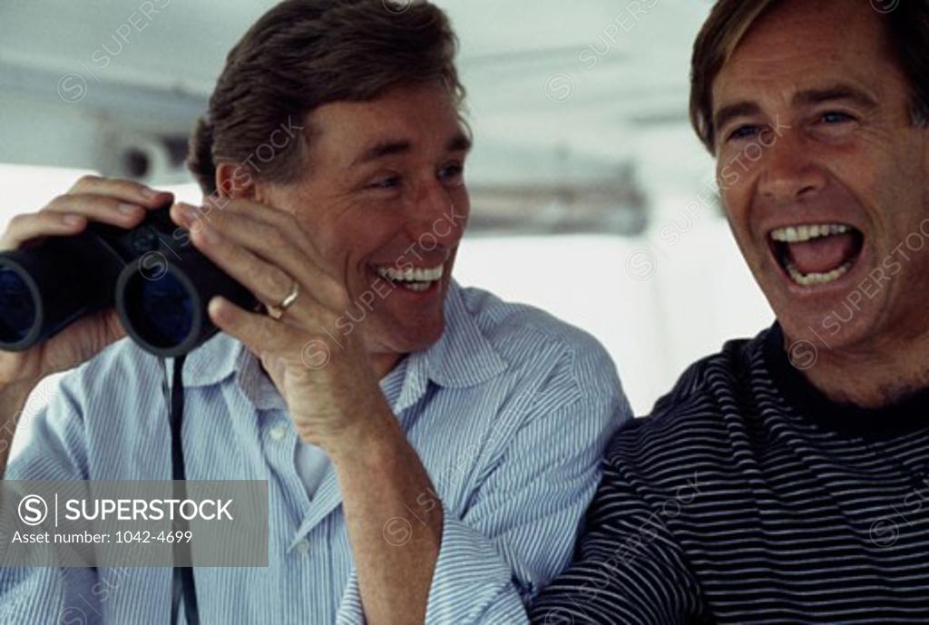 Stock Photo: 1042-4699 Close-up of a mature man shouting and his friend smiling