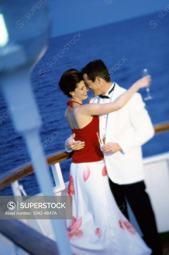 Stock Photo: 1042-4847A Side profile of a young couple dancing on a cruise ship