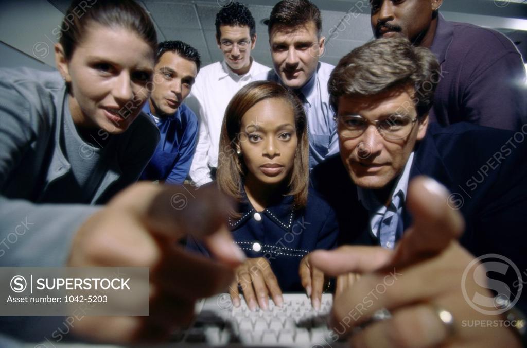 Stock Photo: 1042-5203 Portrait of business executives pointing forward
