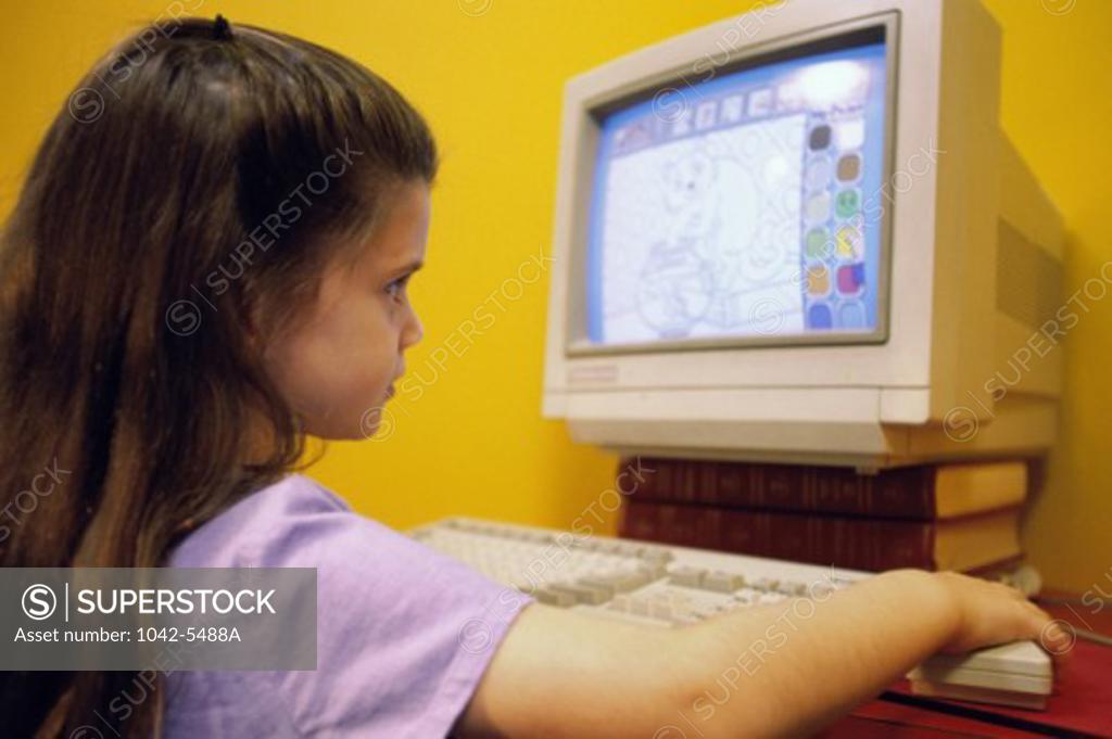Stock Photo: 1042-5488A Side profile of a girl using a computer