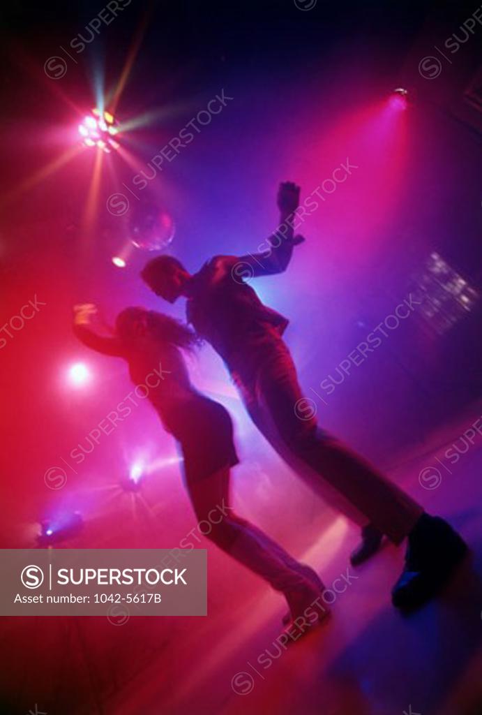 Stock Photo: 1042-5617B Low angle view of a young couple dancing in a nightclub