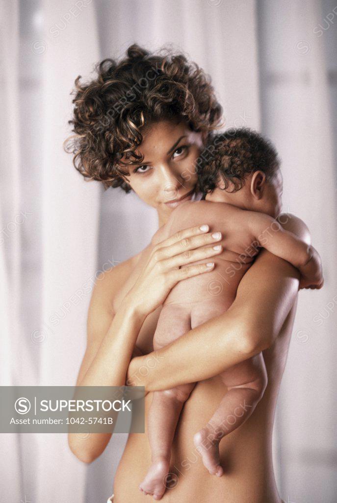 Stock Photo: 1042-5741B Young woman carrying a baby