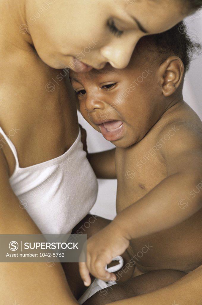 Stock Photo: 1042-5762 Close-up of a mother holding her crying baby boy