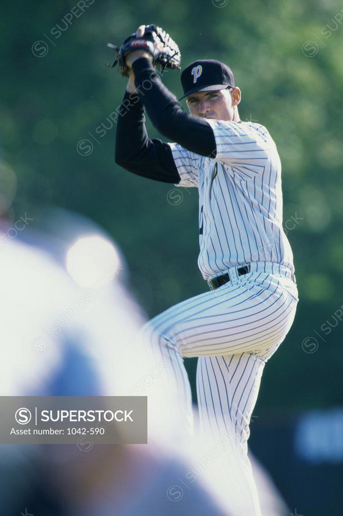 Stock Photo: 1042-590 Baseball player pitching a baseball