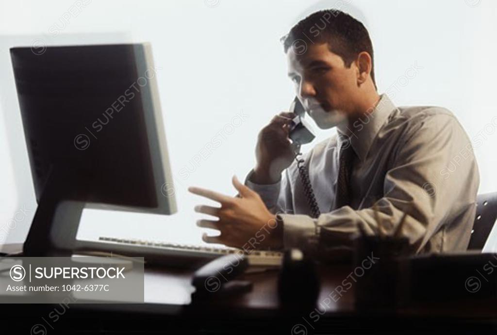 Stock Photo: 1042-6377C Businessman talking on the telephone