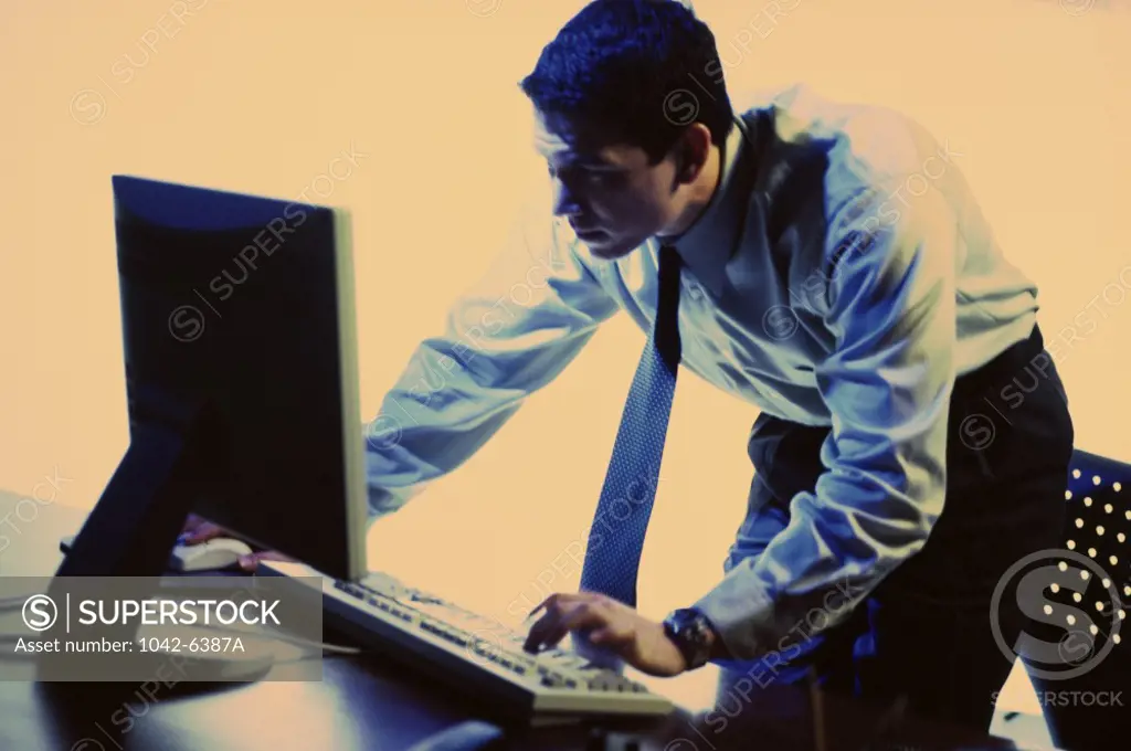 Side profile of a businessman using a computer