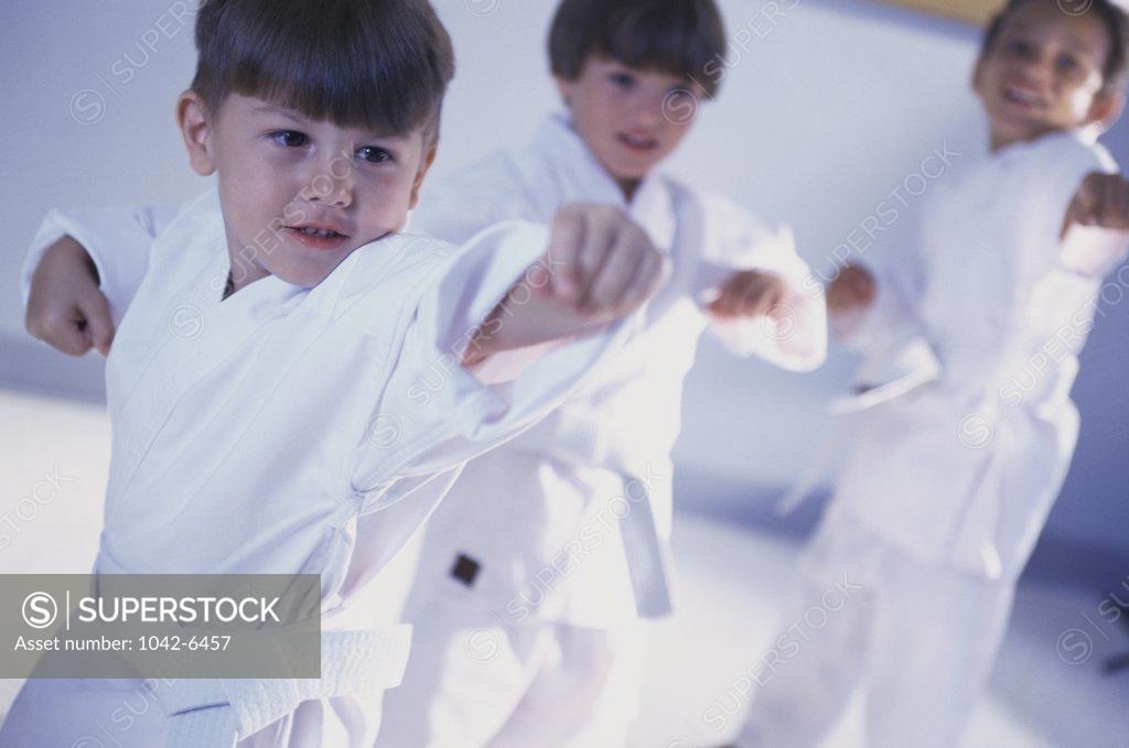 Stock Photo: 1042-6457 Three boys practicing karate