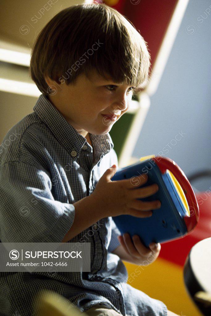 Stock Photo: 1042-6466 Close-up of a boy playing with a toy