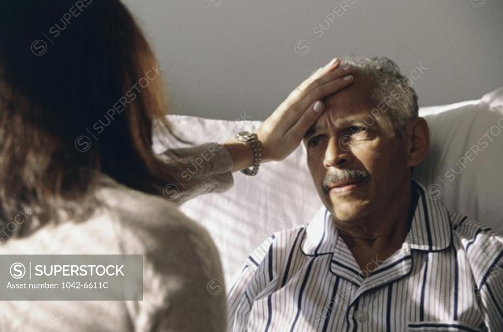 Stock Photo: 1042-6611C Close-up of a female doctor touching a male patient's forehead