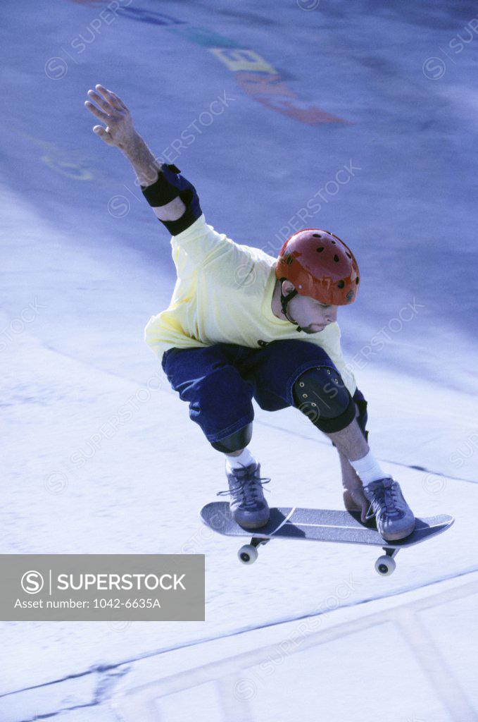Stock Photo: 1042-6635A Young man skateboarding in mid air