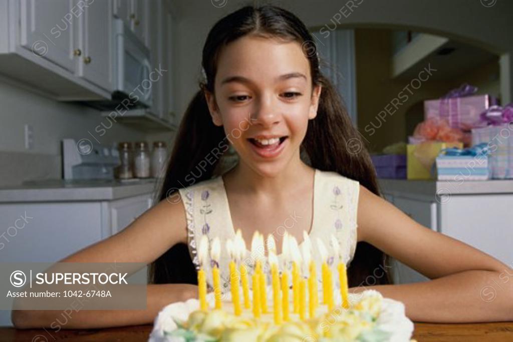 Stock Photo: 1042-6748A Close-up of a girl smiling over a birthday cake