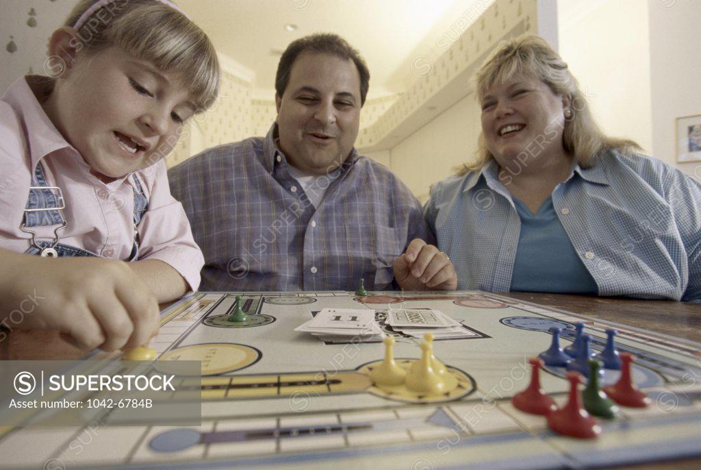 Stock Photo: 1042-6784B Parents playing with their daughter