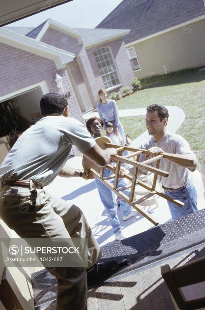Stock Photo: 1042-687 Group of people unloading furniture from a truck