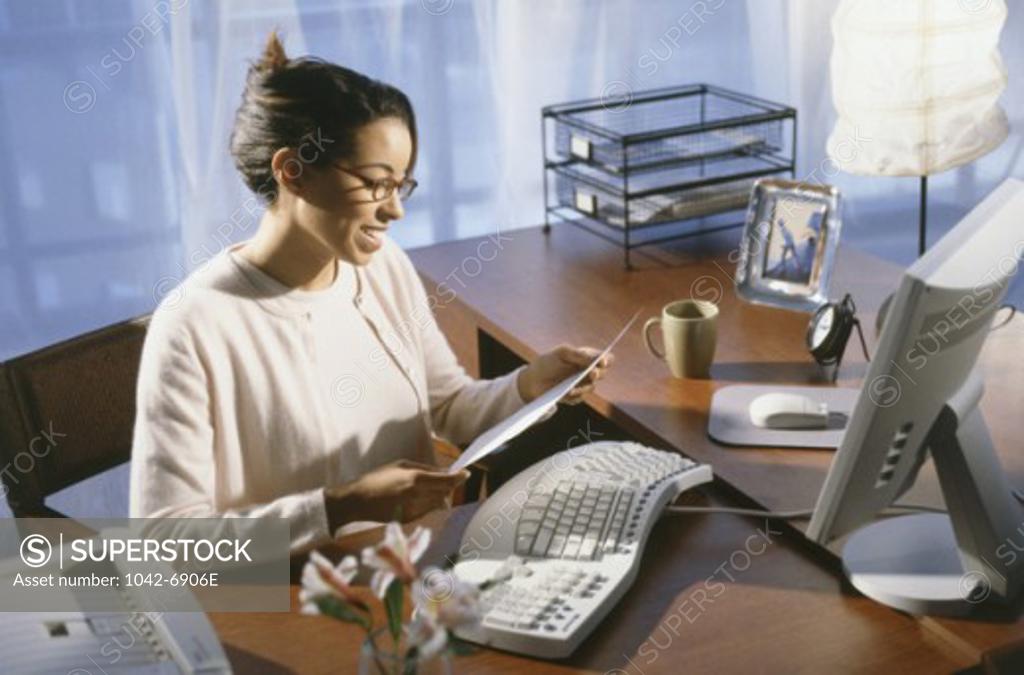 Stock Photo: 1042-6906E Side profile of a businesswoman reading a document