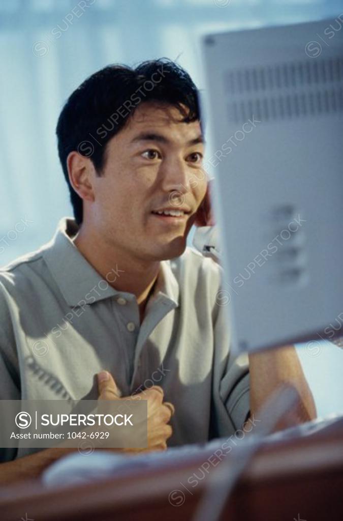 Stock Photo: 1042-6929 Young man talking on the telephone
