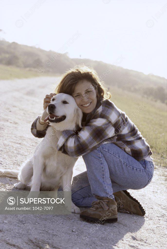 Stock Photo: 1042-7097 Mid adult woman hugging her dog