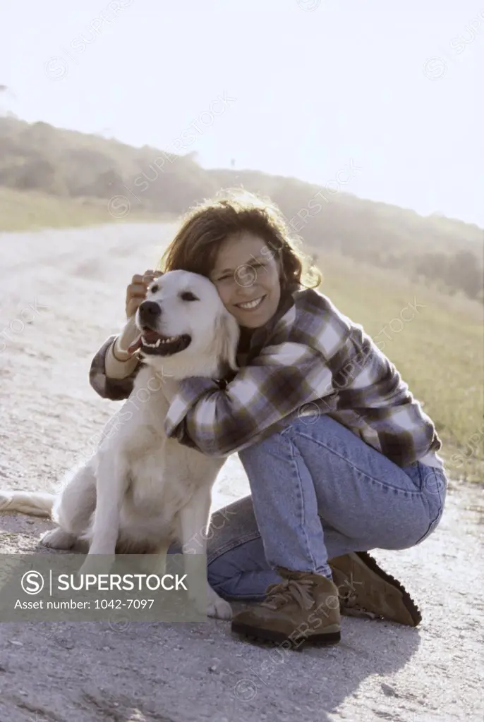 Mid adult woman hugging her dog