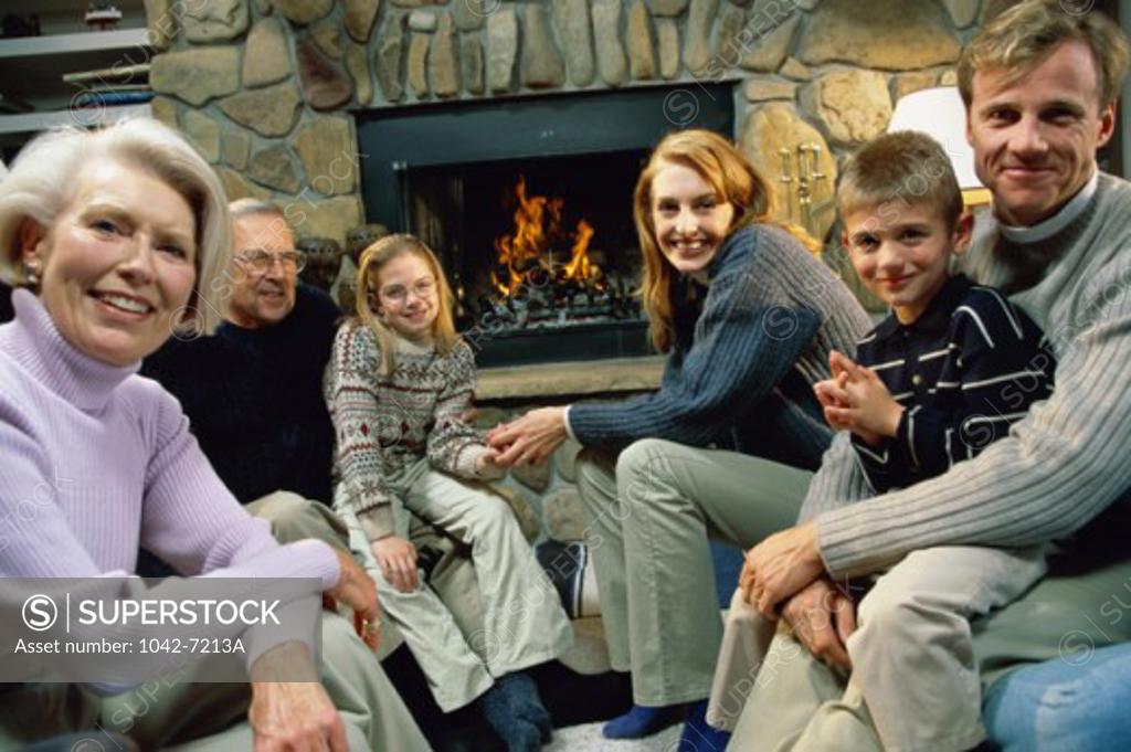 Stock Photo: 1042-7213A Portrait of a family sitting together in front of a fireplace