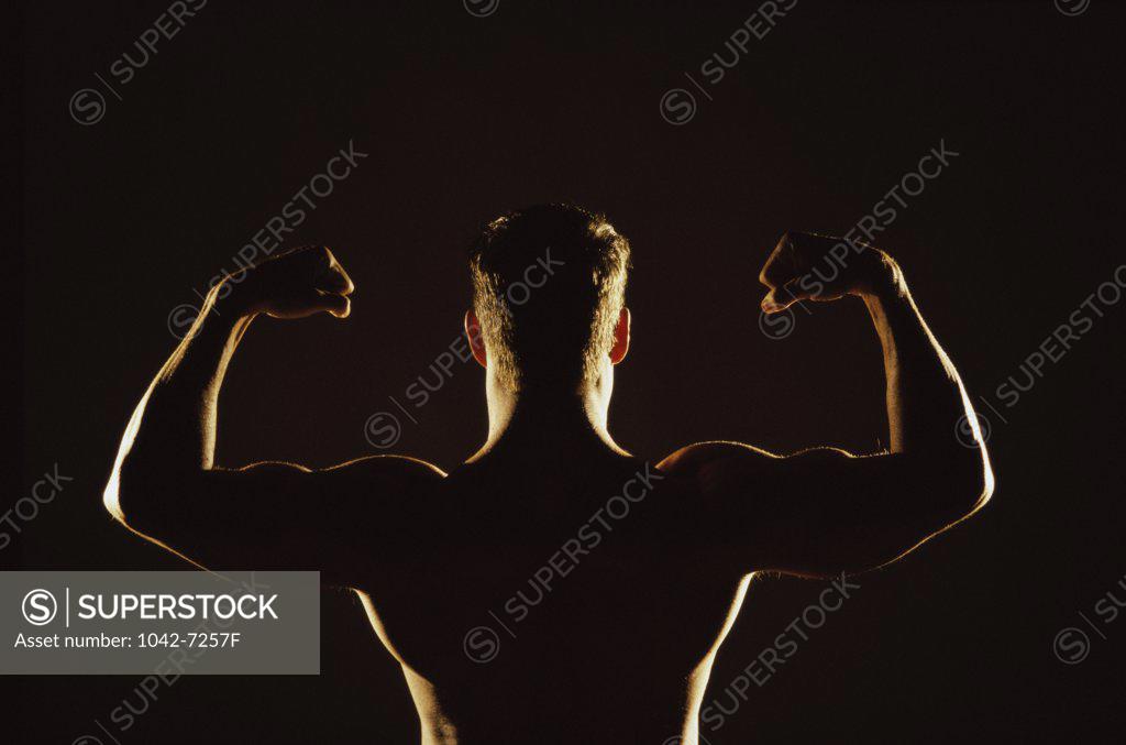 Stock Photo: 1042-7257F Rear view of a young man flexing his muscles