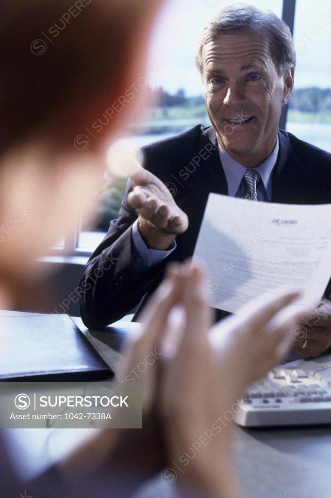 Stock Photo: 1042-7338A Two businessmen talking in an office