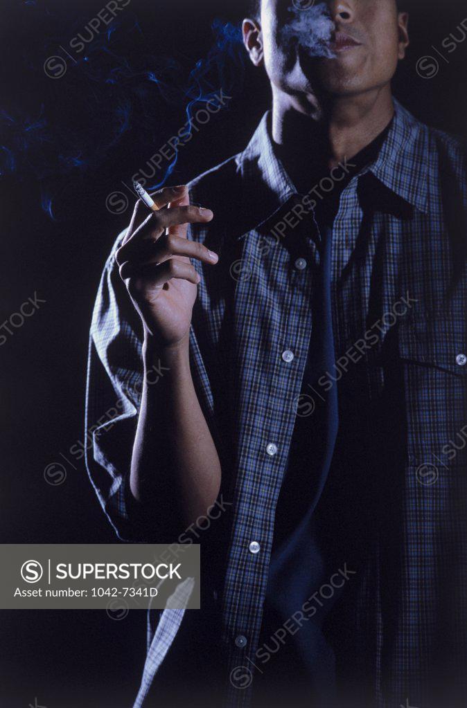 Stock Photo: 1042-7341D Teenage boy holding a cigarette