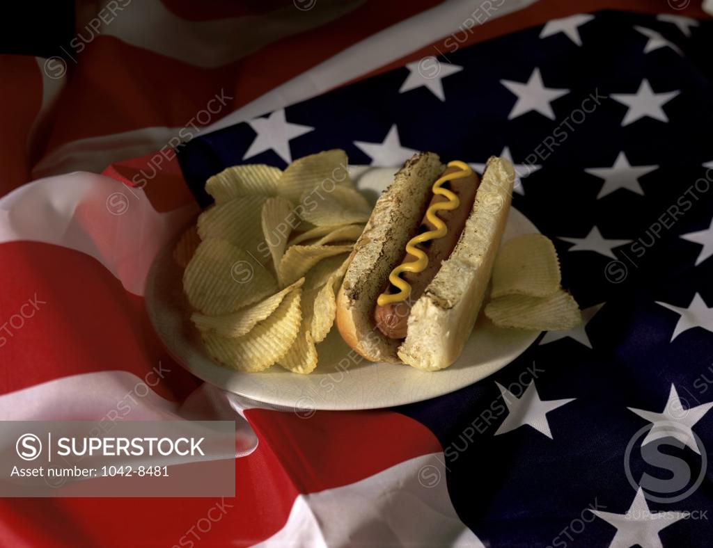 Stock Photo: 1042-8481 Hot dog with potato chips on an American flag