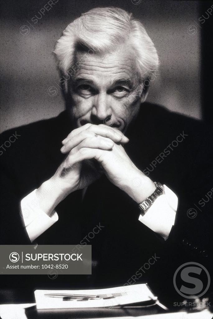 Stock Photo: 1042-8520 Portrait of a businessman with his hands on his chin