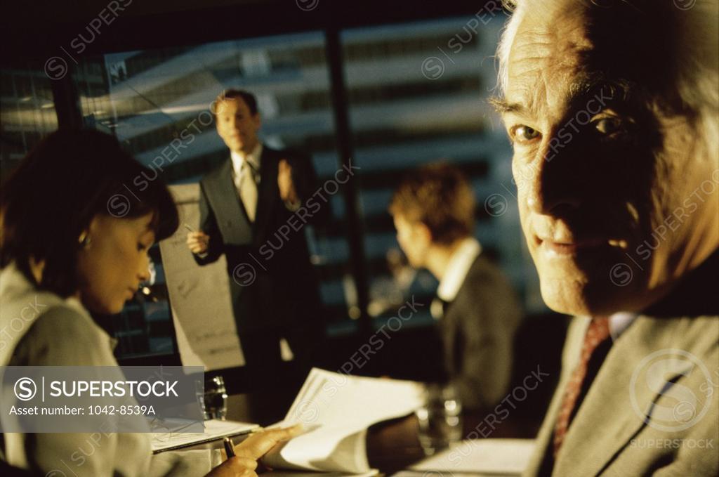 Stock Photo: 1042-8539A Two businessmen and two businesswomen in an office