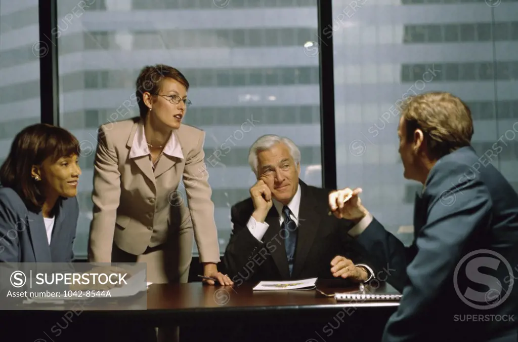 Two businessmen and two businesswomen in an office