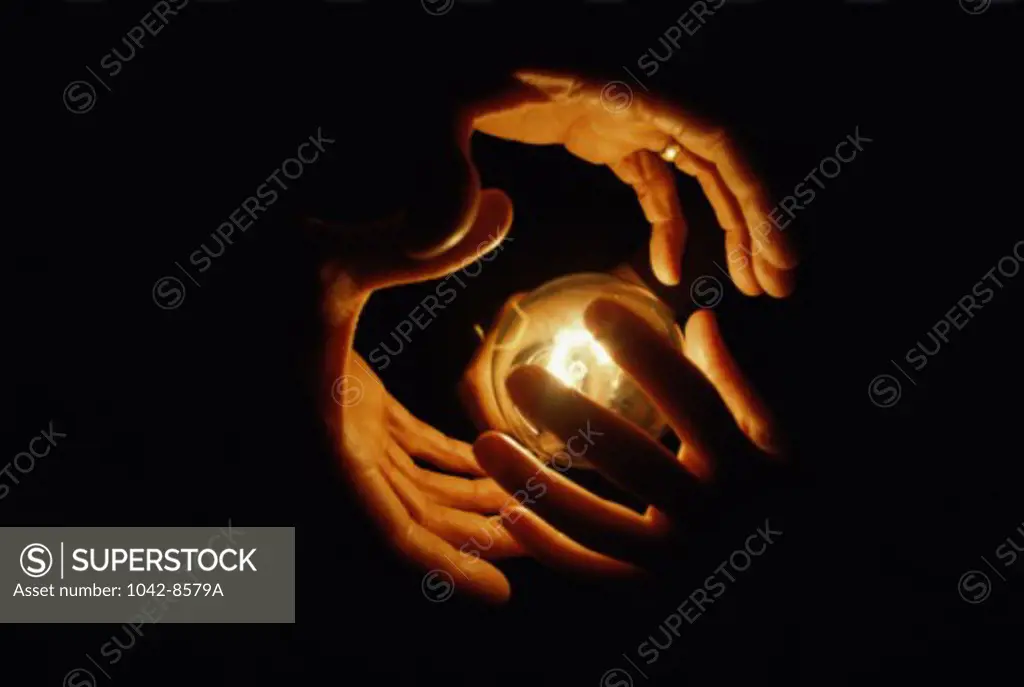 Close-up of a hands surrounding a crystal ball