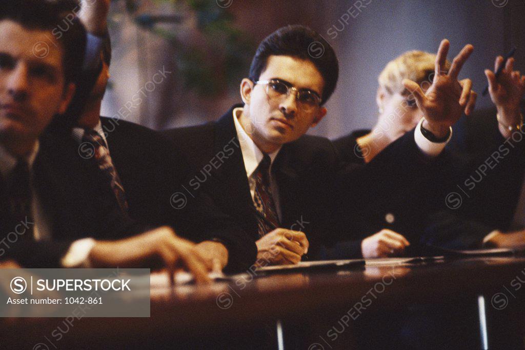 Stock Photo: 1042-861 Three businessmen and a businesswoman in a seminar