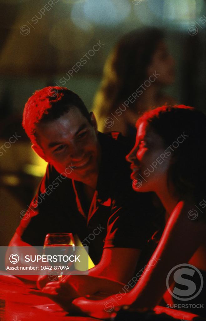 Stock Photo: 1042-8709A Young couple looking at each other in a restaurant