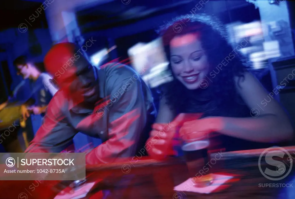 Young couple standing at a bar counter
