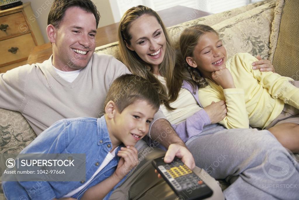 Stock Photo: 1042-9766A Parents watching television with their son and daughter