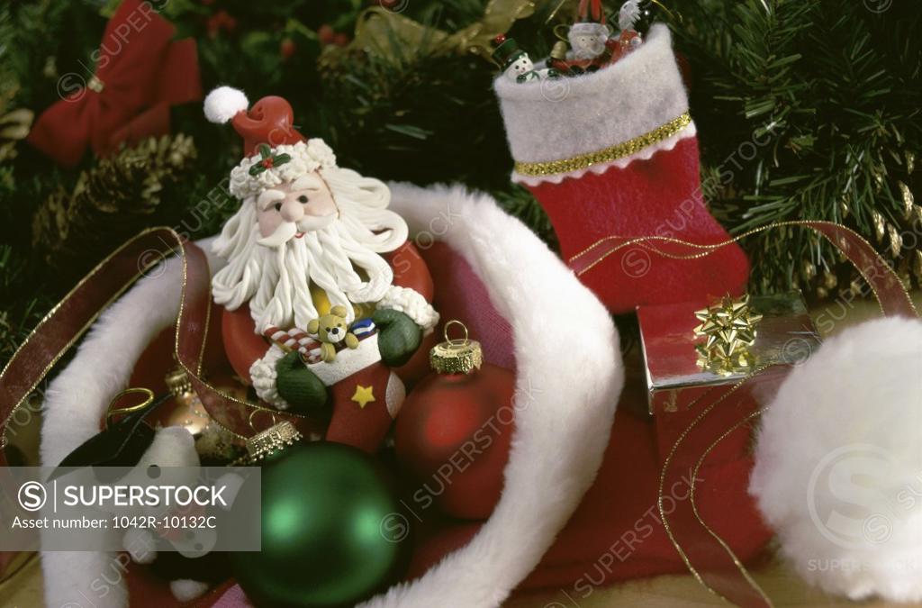 Stock Photo: 1042R-10132C Christmas ornaments and gifts in a Santa hat