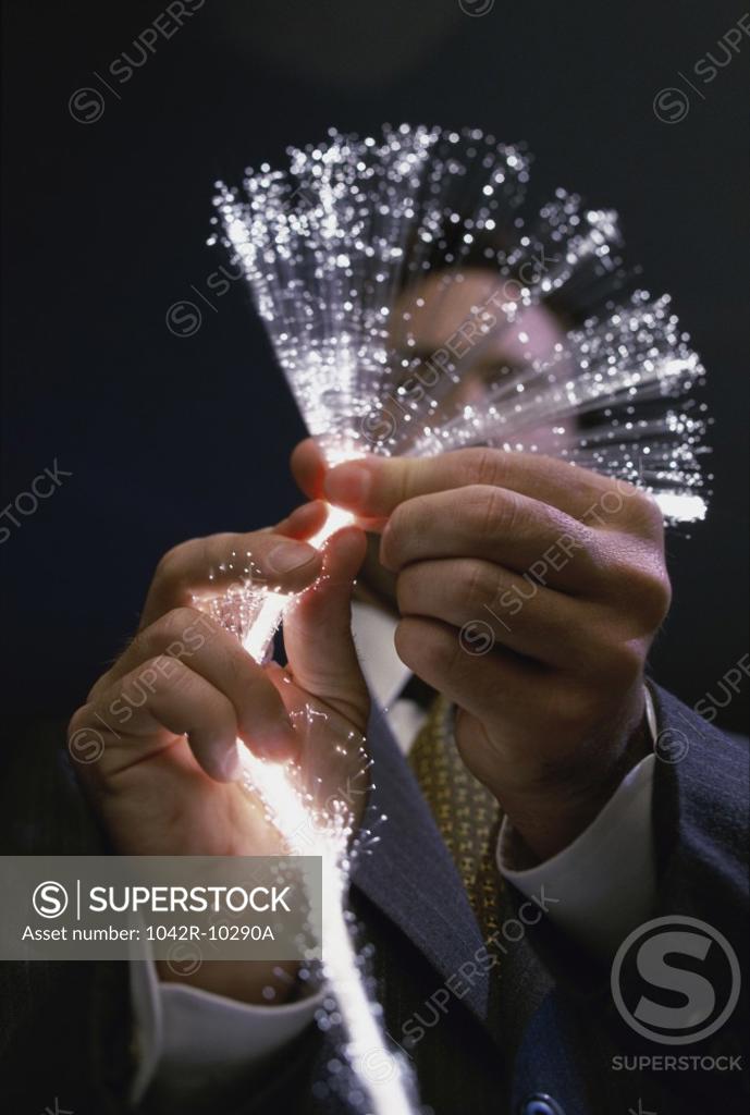 Stock Photo: 1042R-10290A Close-up of a person holding fiber optic cables