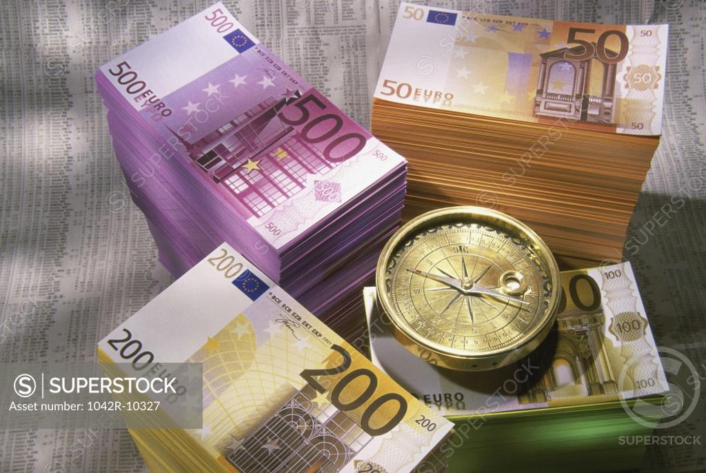 Stock Photo: 1042R-10327 Stack of Euros and a compass