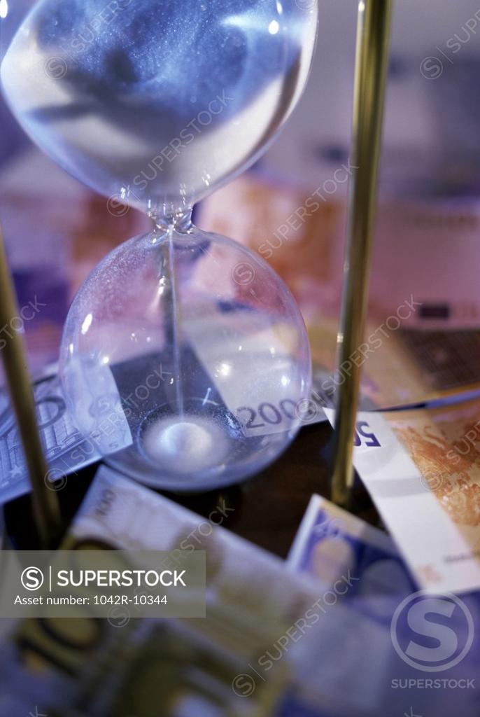 Stock Photo: 1042R-10344 Euro banknotes with an hourglass