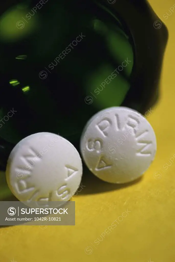 Close-up of an open bottle of aspirin tablets