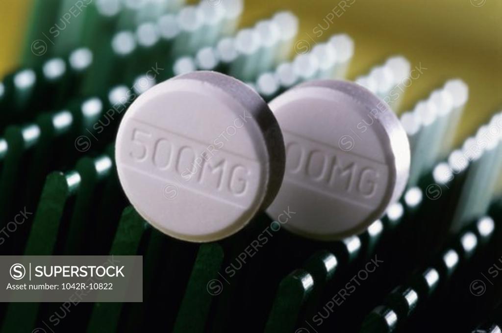 Stock Photo: 1042R-10822 Close-up of two tablets