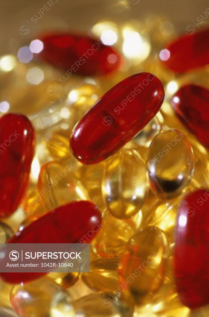 Stock Photo: 1042R-10840 Close-up of a glass full of vitamin capsules