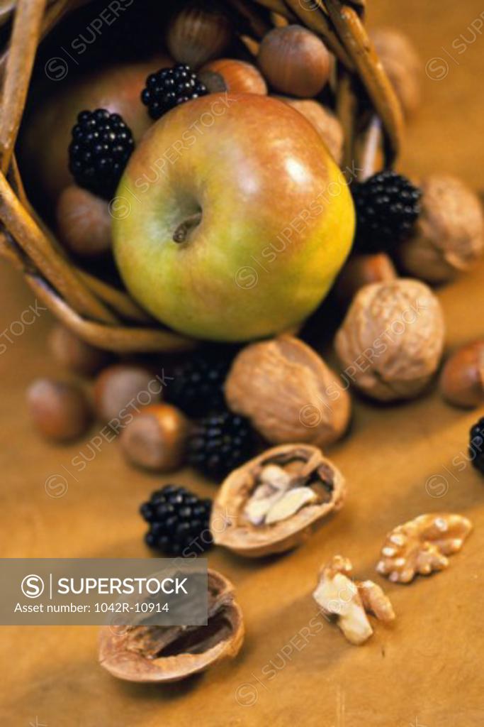 Stock Photo: 1042R-10914 Close-up of fruits and nuts spilling from a basket