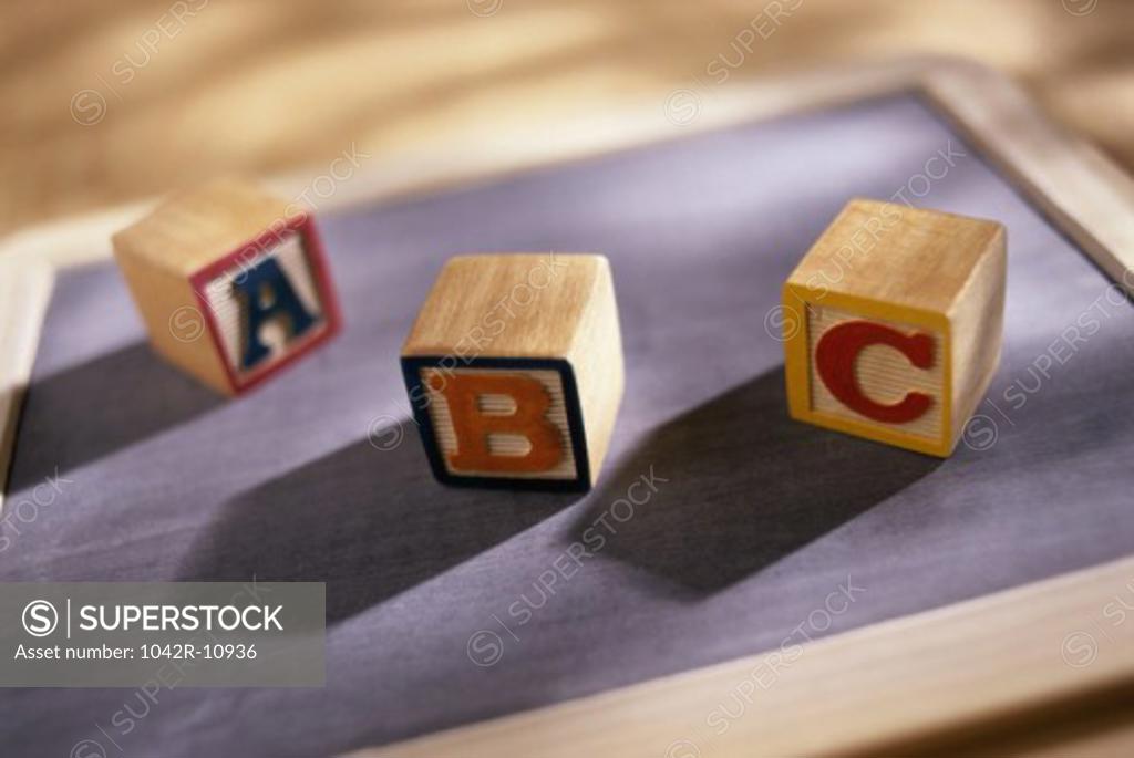 Stock Photo: 1042R-10936 Wooden alphabet blocks on a chalkboard