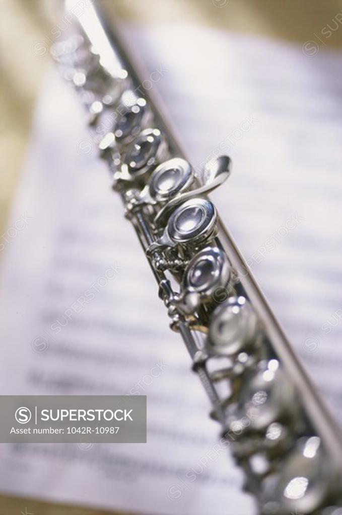 Stock Photo: 1042R-10987 Close-up of a flute on music sheets