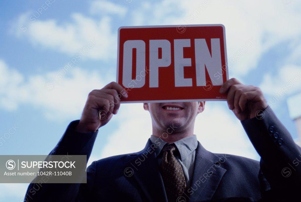 Stock Photo: 1042R-11040B Close-up of a businessman holding an open sign