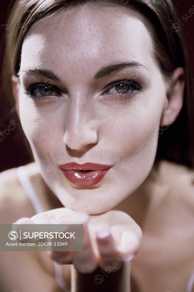 Stock Photo: 1042R-11049 Portrait of a young woman blowing a kiss
