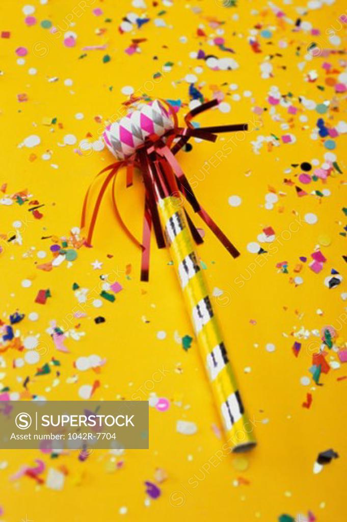 Stock Photo: 1042R-7704 Close-up of a party horn blower and confetti