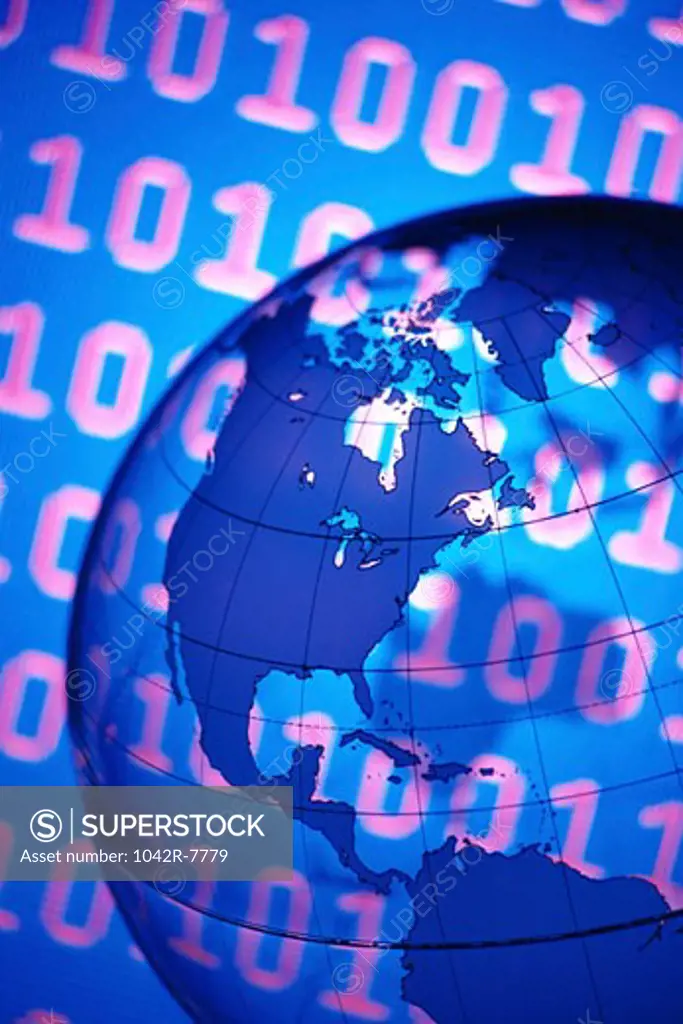 Close-up of a globe superimposed over binary code